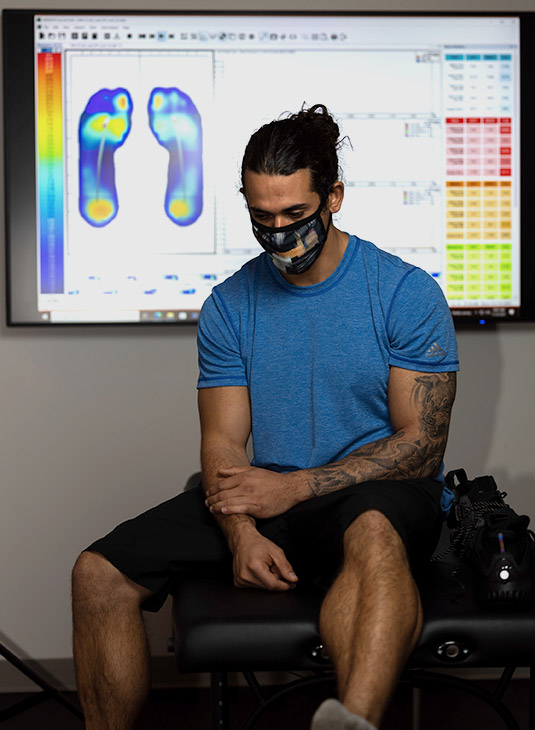 Test subject near screen with foot mapping data