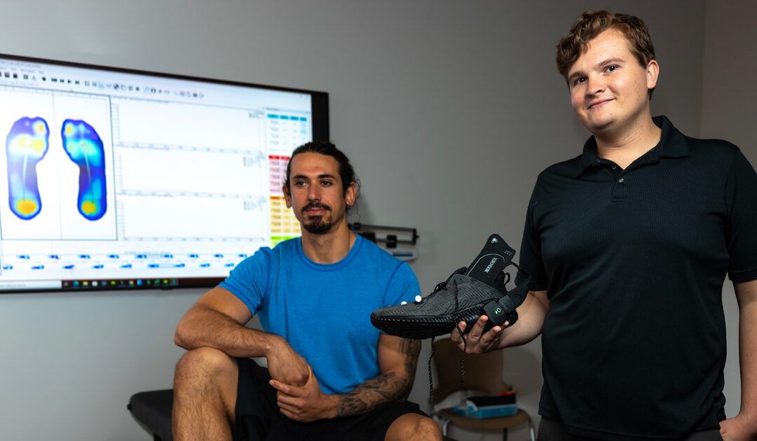 Biomechanics Pressure Testing scientist and subject in lab with foot heat map